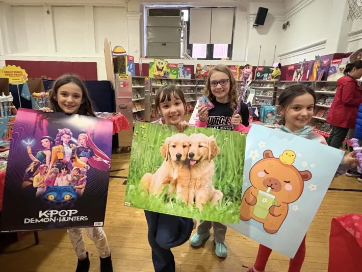 Connors kids showing off posters at the Scholastic Book Fair