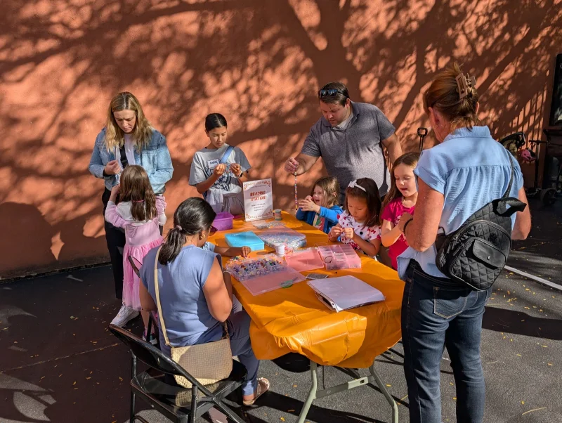 Families and kids at the beading station during the Connors Fall Festival