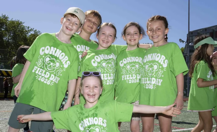 Smiling Connors kids in bright green Field Day shirts