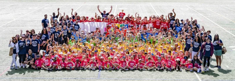 The whole Connors school community gathered on the field in rainbow-colored Field Day shirts