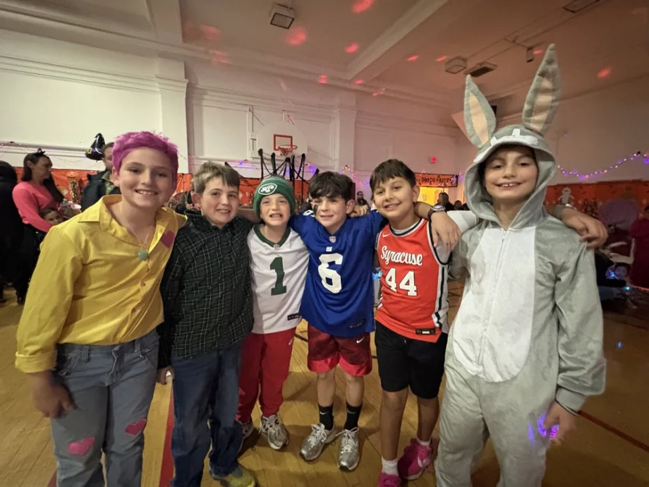 A group of boys in costumes at the dance