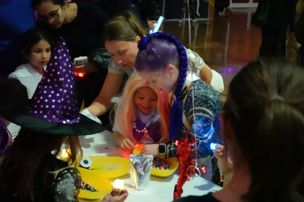 Kids and parents at the craft table