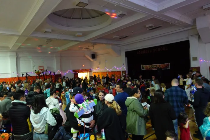 A packed crowd of costumed families at the Connors Halloween Dance