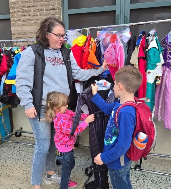 A Connors mom and her kids picking out a costume