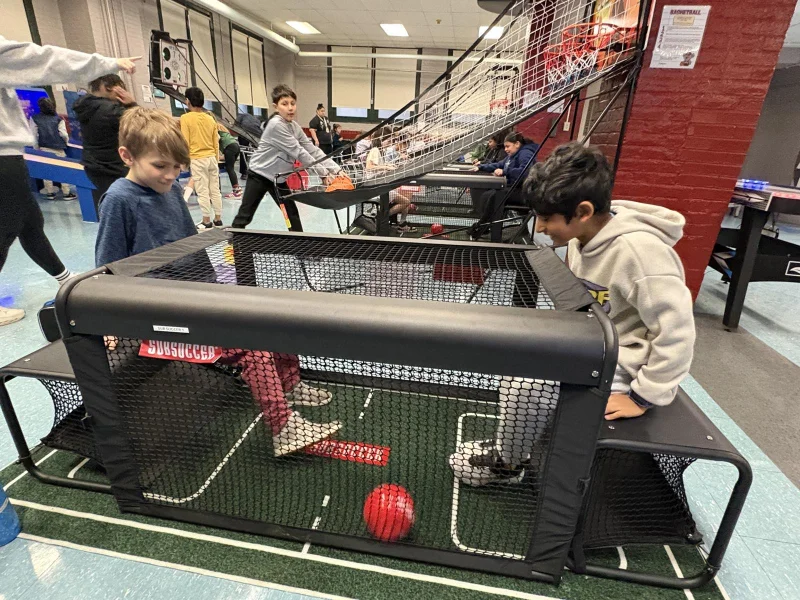 Connors students playing arcade games at a school game night
