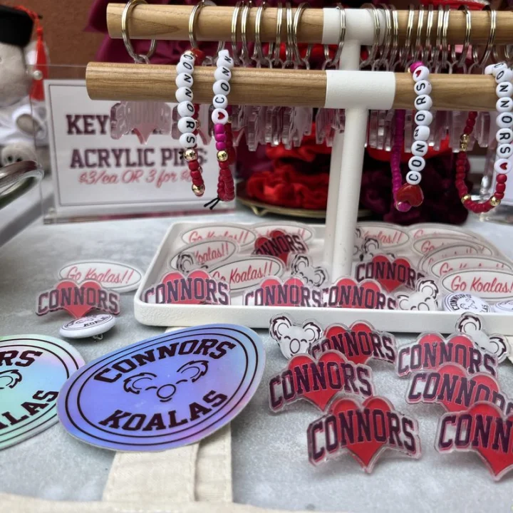 Connors heart pins, Go Koalas buttons, beaded keychains, and holographic Koala stickers