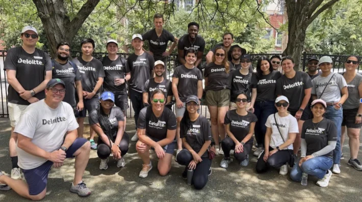 A corporate partner team out volunteering together in the park