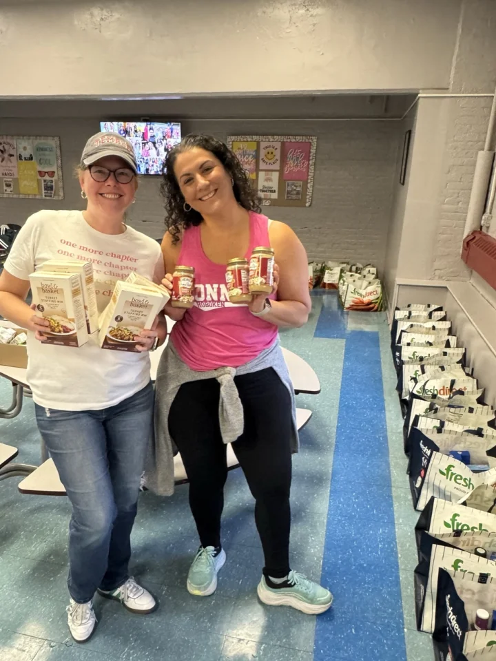 Parents assembling Thanksgiving dinner baskets for Connors families